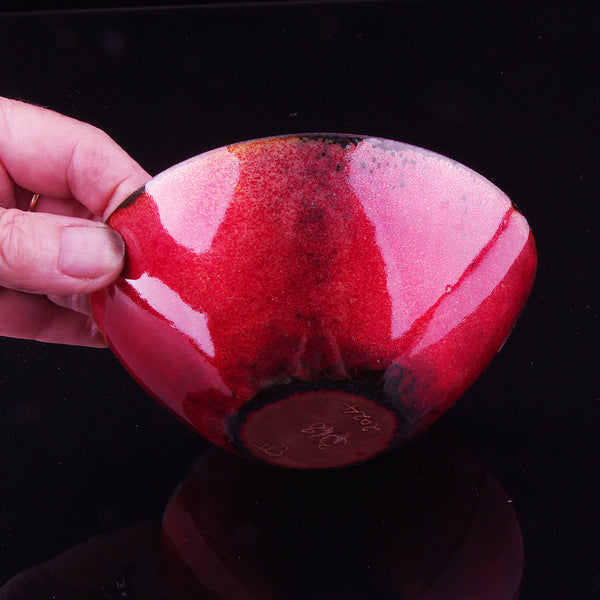 Red black, red and white enamelled copper dish