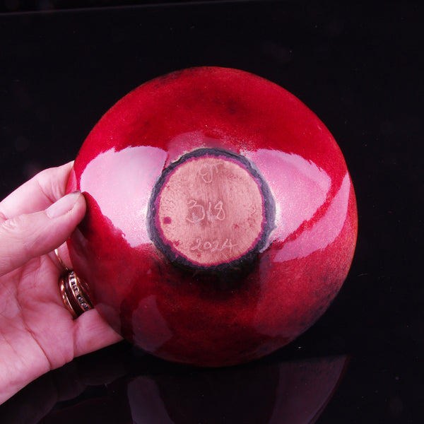 Red black, red and white enamelled copper dish