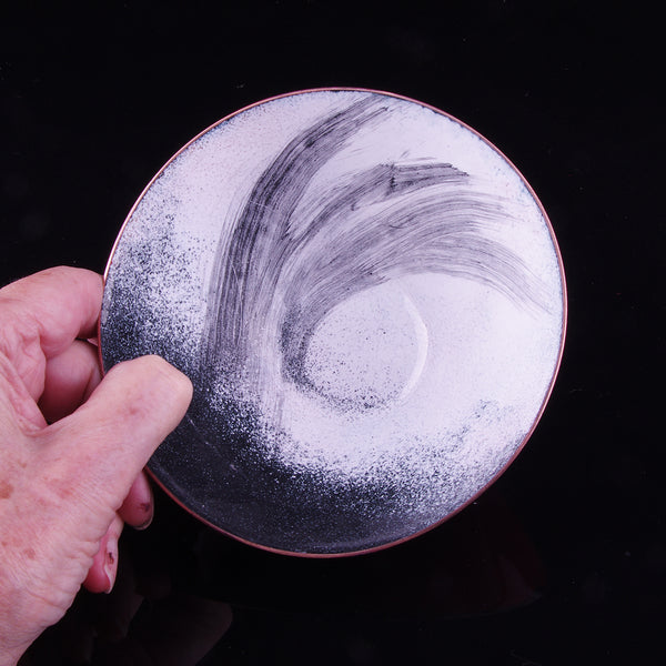 Red black, red and white enamelled copper dish
