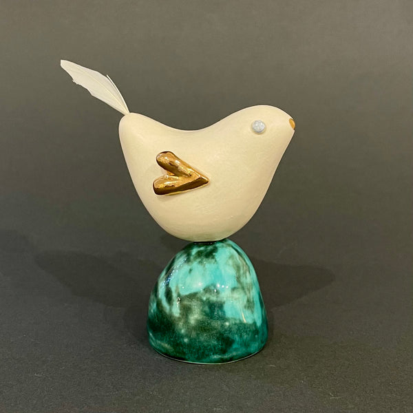 Bird on green pedestal  by Sophie Smith