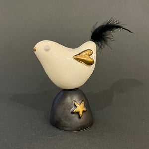Bird on black pedestal by Sophie Smith