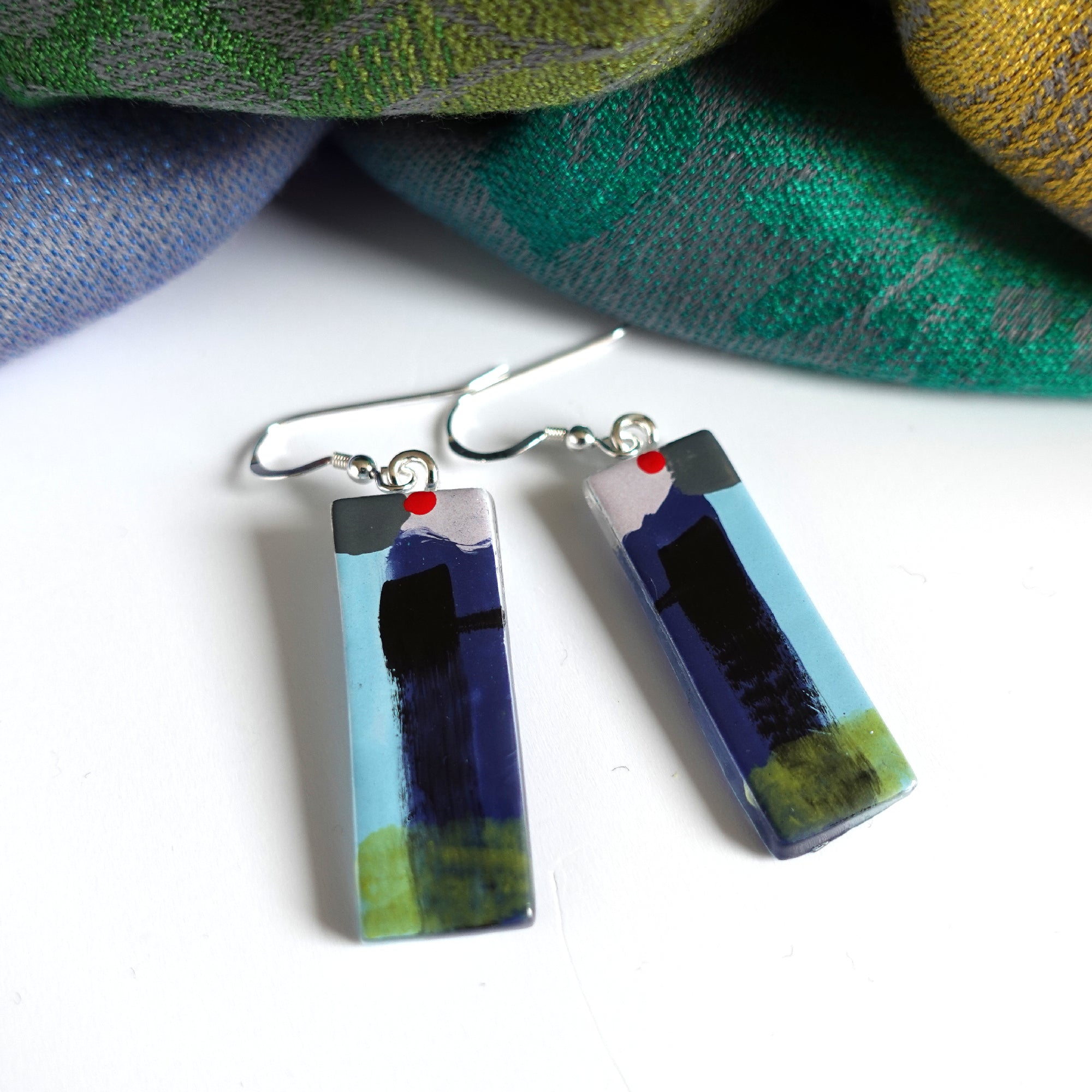 Bright abstract fused glass earrings in navy lilac and blue with red dot to high light. Sterling silver ear wires. 35 x 12mm