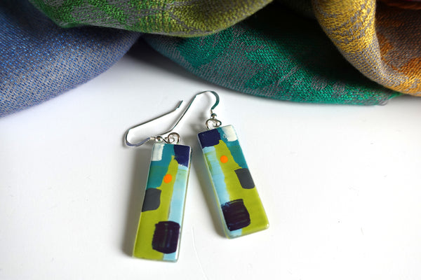 Abstract design in bright green and orange  with more subtle blues. 3.5 x 1.2cms rectangular. Silver ear wires