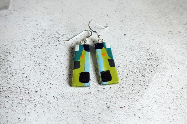 Bright, colourful. abstract fused glass and enamel earrings. Sterling silver ear wires. Rectangular in shape. 35mm dangles. Lime green, blues , nlack and white, abstract design