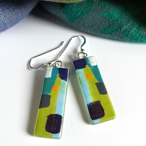 Bright abstract earrings in enamel on fused glass with silver ear wires . 3.5cm x 1,2cms