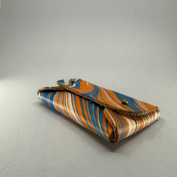 Angled left side and base of the purse