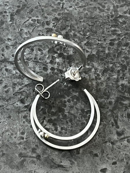 Silver hoop earrings with boulder ball detail.