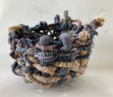 Hand woven textile basket