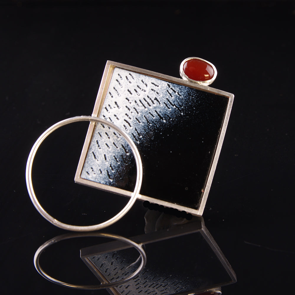 Black and white enamelled brooch