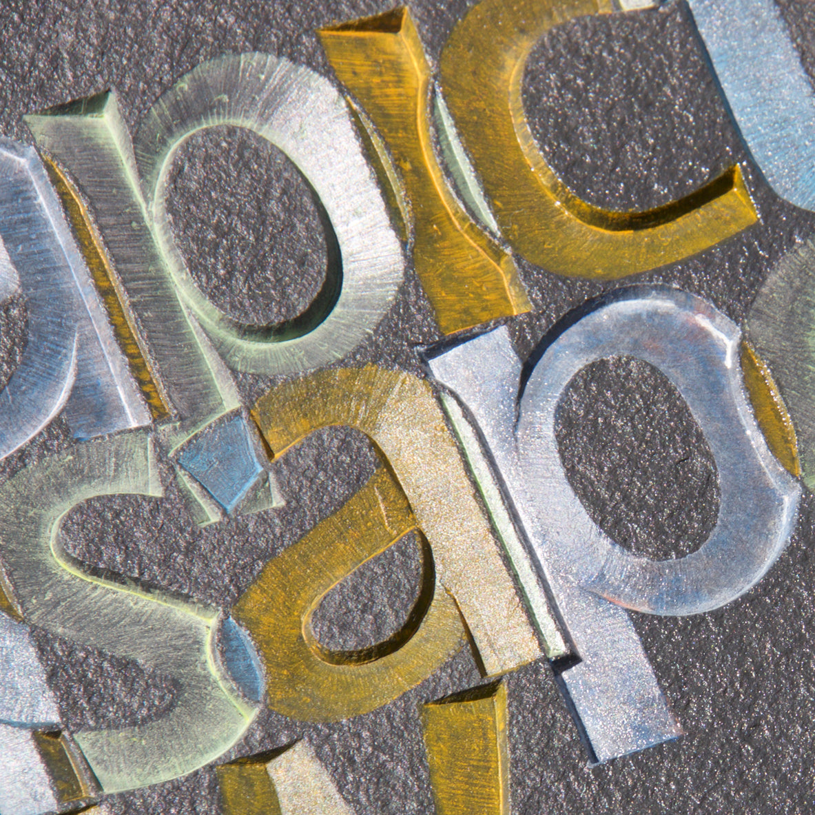 A picture paints.  Carved and coloured grey slate  by Annet Stirling